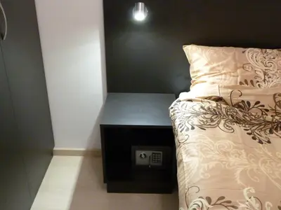 a bedroom with a bed with a night stand next to it at The Place in Ljubljana