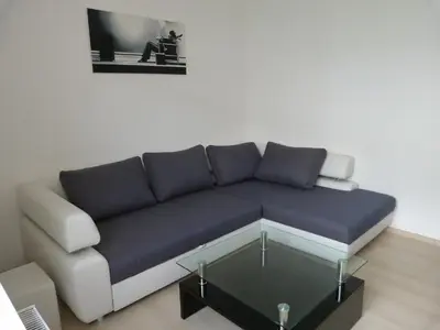 a living room with a couch and a glass table at The Place in Ljubljana