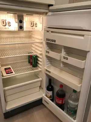 an open refrigerator filled with drinks and alcohol at The Place in Ljubljana