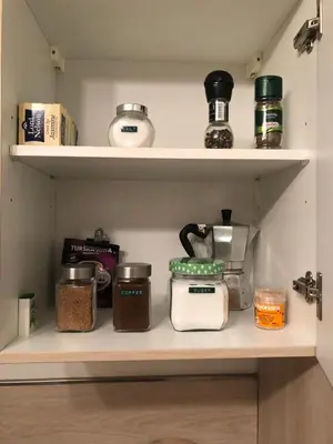 a kitchen shelf with various items on it at The Place in Ljubljana