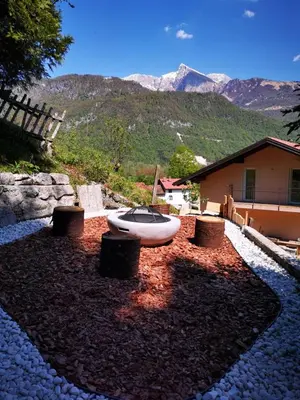 a bath tub sitting in the yard of a house at Cosy cottage with views near Kobarid in Kobarid
