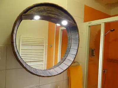 a mirror on the wall of a bathroom at Beer & wine cellar in Ljubljana