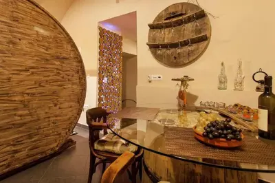 a kitchen with a glass table and a bowl of grapes at Beer & wine cellar in Ljubljana