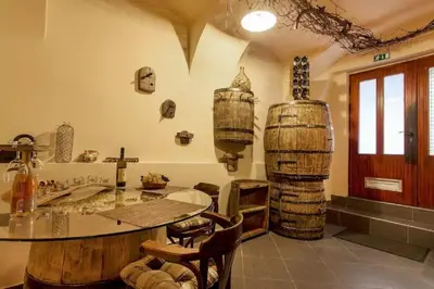a room with a table and some wine barrels at Beer & wine cellar in Ljubljana
