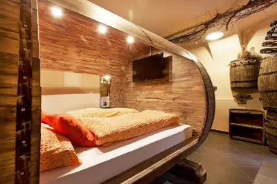 a mirror in a room with a bed in it at Beer & wine cellar in Ljubljana