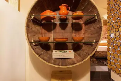 a shelf filled with pots and pans on a wall at Beer & wine cellar in Ljubljana