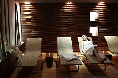 a woman sitting in chairs in a room at Hotel Marinšek in Naklo