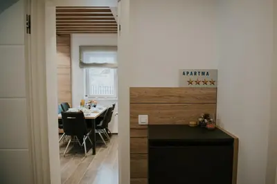 a kitchen and dining room with a table and a door at Villa Mojca - Jasna&Jelka Apartments, Central Location with Private Garage and Alpine View in Kranjska Gora