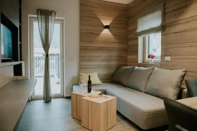 a living room with a couch and a table at Villa Mojca - Jasna&Jelka Apartments, Central Location with Private Garage and Alpine View in Kranjska Gora