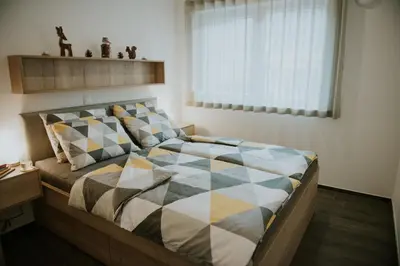 a bedroom with a large bed with a large window at Villa Mojca - Jasna&Jelka Apartments, Central Location with Private Garage and Alpine View in Kranjska Gora