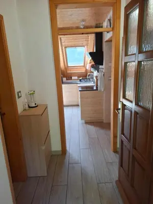 a room with a kitchen with a door and a floor at APARTMA ANA IDA in Srpenica