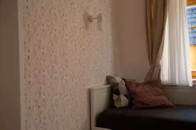a bedroom with a bed and a window at Apartments Tourist Farm Štorman with EV Ch-Station in Tržič
