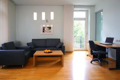 a living room with a couch and a table at Apartments Villa Boltez in Kranj
