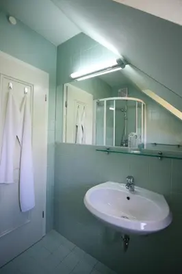 a bathroom with a sink and a mirror at Apartments Villa Boltez in Kranj