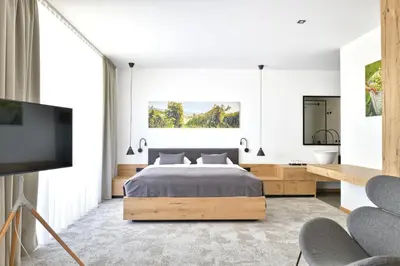 a bedroom with a bed and a flat screen tv at Guest House Vračko in Zgornja Kungota