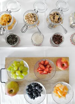 a table with bowls of fruit and other foods at Guest House Vračko in Zgornja Kungota