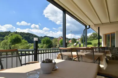 a table and chairs on a balcony with a view at Guest House Vračko in Zgornja Kungota