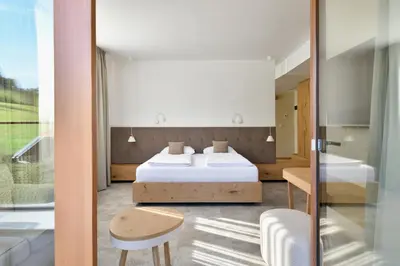 a bedroom with two beds and a table and a chair at Guest House Vračko in Zgornja Kungota
