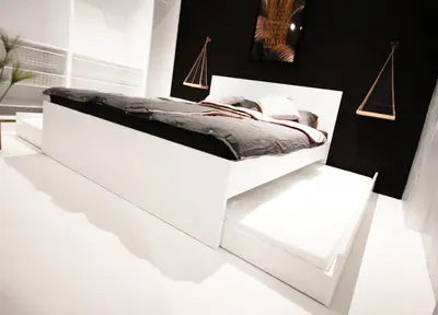 a white bed in a room with a black wall at CASA GLITTER in Ljubljana