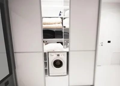 a closet with a washer and dryer in it at CASA GLITTER in Ljubljana