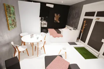a small room with a table and chairs and a bed at CASA GLITTER in Ljubljana