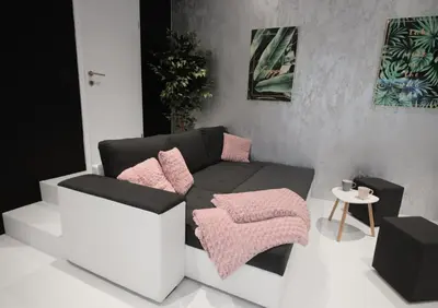 a living room with a black and white couch and pink pillows at CASA GLITTER in Ljubljana