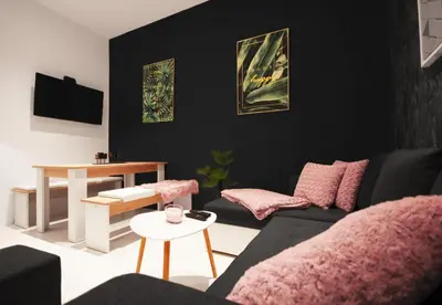 a living room with a couch and a table at CASA GLITTER in Ljubljana