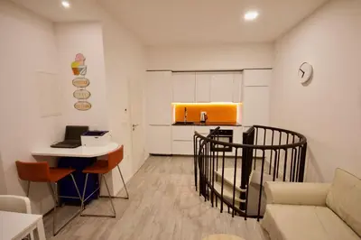 a living room with a couch and a table and a kitchen at Albina apartment in Ljubljana
