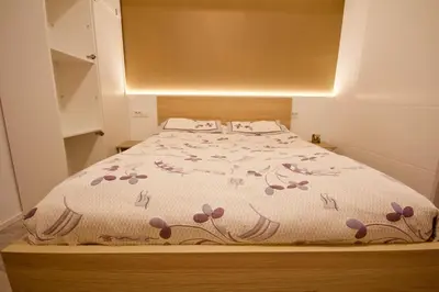 a bedroom with a bed with a floral bedspread at Albina apartment in Ljubljana