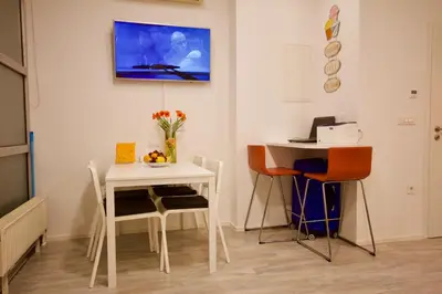 a dining room with a table and a table and chairs at Albina apartment in Ljubljana