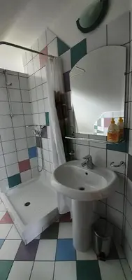 a bathroom with a sink and a shower at Apartma Smučka pod Roglo in Zreče
