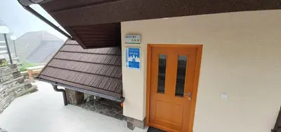 a building with a door and a balcony at Apartma Smučka pod Roglo in Zreče