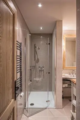 a bathroom with a shower with a tub and a sink at B&B Dvor Tacen in Ljubljana