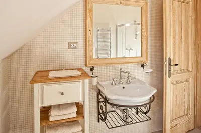 a bathroom with a sink and a mirror at B&B Dvor Tacen in Ljubljana