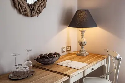 a table with a lamp and a bowl of fruit on it at B&B Dvor Tacen in Ljubljana