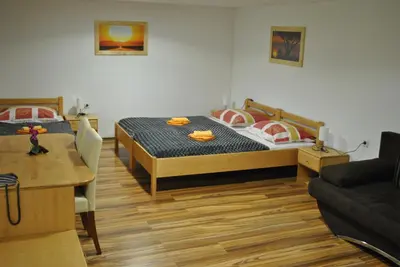 a bedroom with a bed and a couch at Guest House Čater in Laško