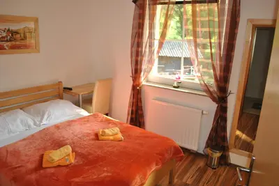 a bedroom with a bed with two towels on it at Guest House Čater in Laško