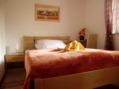 a bedroom with a bed with a yellow blanket on it at Guest House Čater in Laško