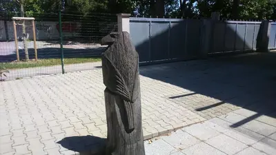 a wooden statue of a bird on a sidewalk at Vila Ema Apartments and Rooms in Ljubljana
