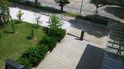 an overhead view of a park with a bench on a sidewalk at Vila Ema Apartments and Rooms in Ljubljana