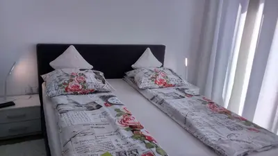 a bed with two pillows on top of it at Vila Ema Apartments and Rooms in Ljubljana