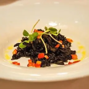 a plate of food with carrots and black beans at Guest House pri Vodniku in Ljubljana