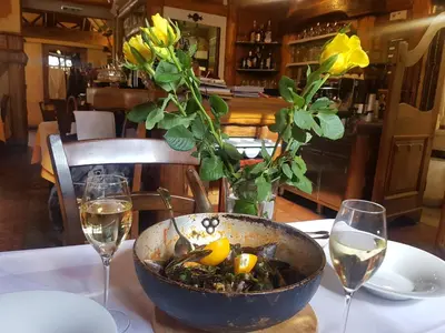 a bowl of food on a table with two wine glasses at Guest House pri Vodniku in Ljubljana