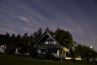 a house sitting on top of a field at night at Entire house Iris & Arnika in Bled