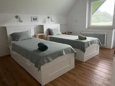 a bedroom with two beds with hats on them at Entire house Iris & Arnika in Bled
