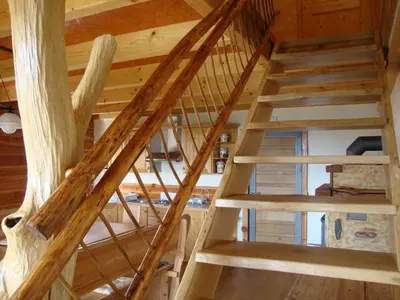 a wooden staircase in a log cabin at Apartments Za Grapo in Cerkno
