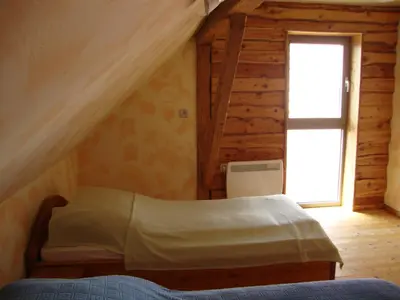 a bedroom with a bed and a window at Apartments Za Grapo in Cerkno
