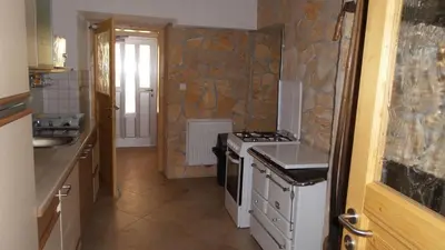 a small kitchen with a stove and a sink at Apartments Za Grapo in Cerkno