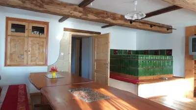 a kitchen with a wooden table in a room at Apartments Za Grapo in Cerkno