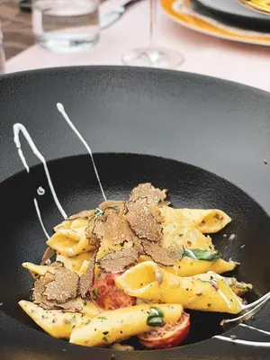 a frying pan with pasta and meat on it at Hiša Aleš in Kranj